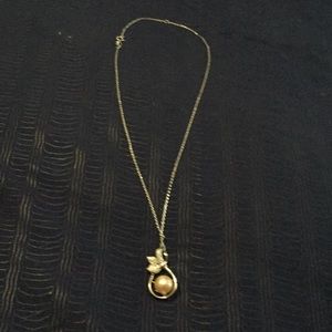 Necklace with a pink pearl.